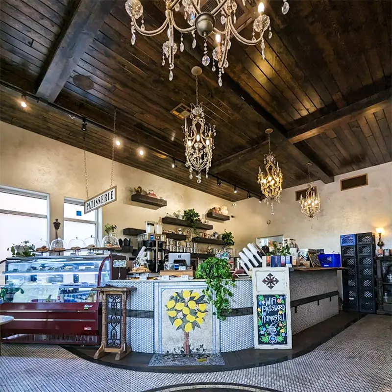 Interior of Riverside FeelLove Coffee with wood ceilings and gold accents.